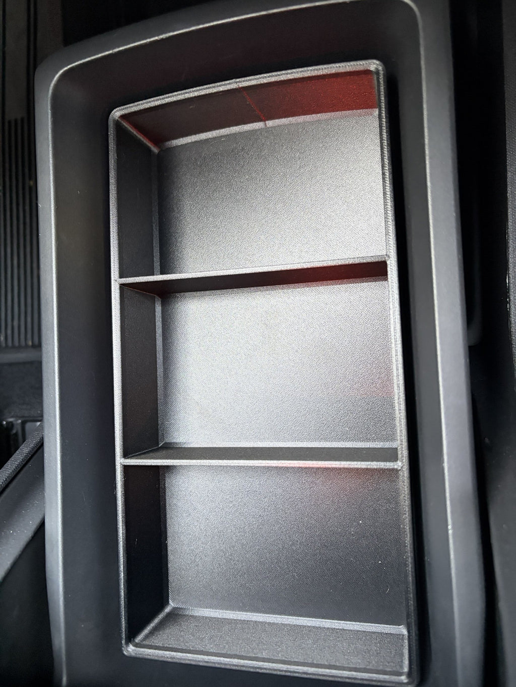 Empty Slide-Out Drawer Tray installed in a Rivian R2 console drawer showing its three open sections